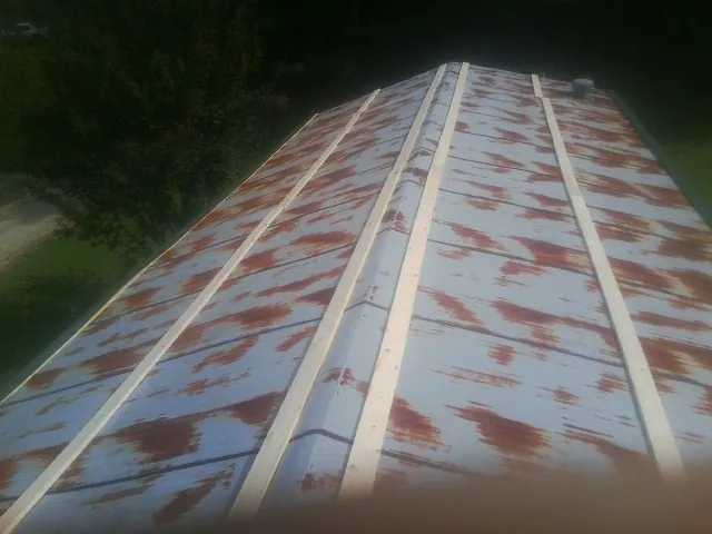 Rusted metal roof panels with new wood purlins before replacement — Storm Damage Roof Repair in Waynetown by Roofing Brothers